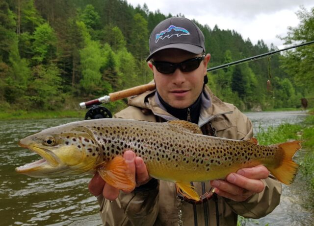 Patagonia hat, squirmy wormie fly and big brown trout